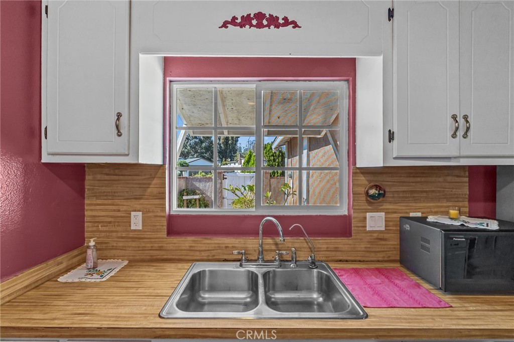 820 Cozy Court Fallbrook, CA 92028 - Photo 14 of 38 a kitchen with stainless steel appliances granite countertop a sink stove and cabinets