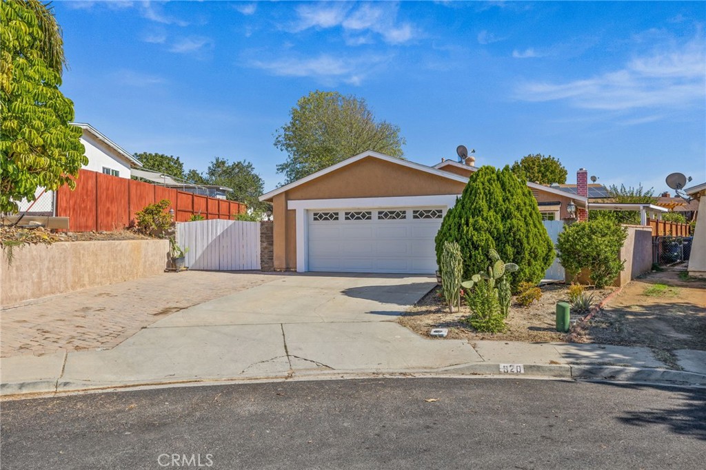 820 Cozy Court Fallbrook, CA 92028 - Photo 2 of 38 a front view of a house with a yard and garage