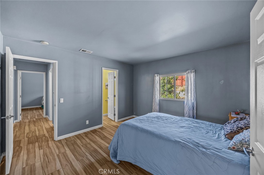 820 Cozy Court Fallbrook, CA 92028 - Photo 21 of 38 a bedroom with a bed and a wooden floor