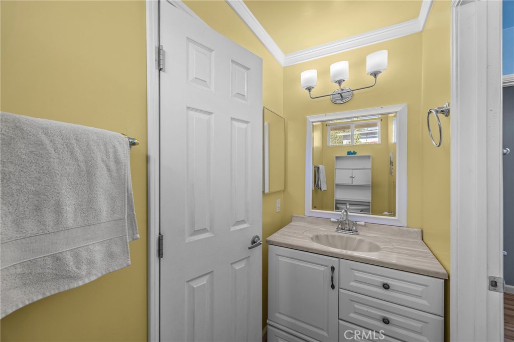 820 Cozy Court Fallbrook, CA 92028 - Photo 22 of 38 a bathroom with a granite countertop sink a mirror and a shower