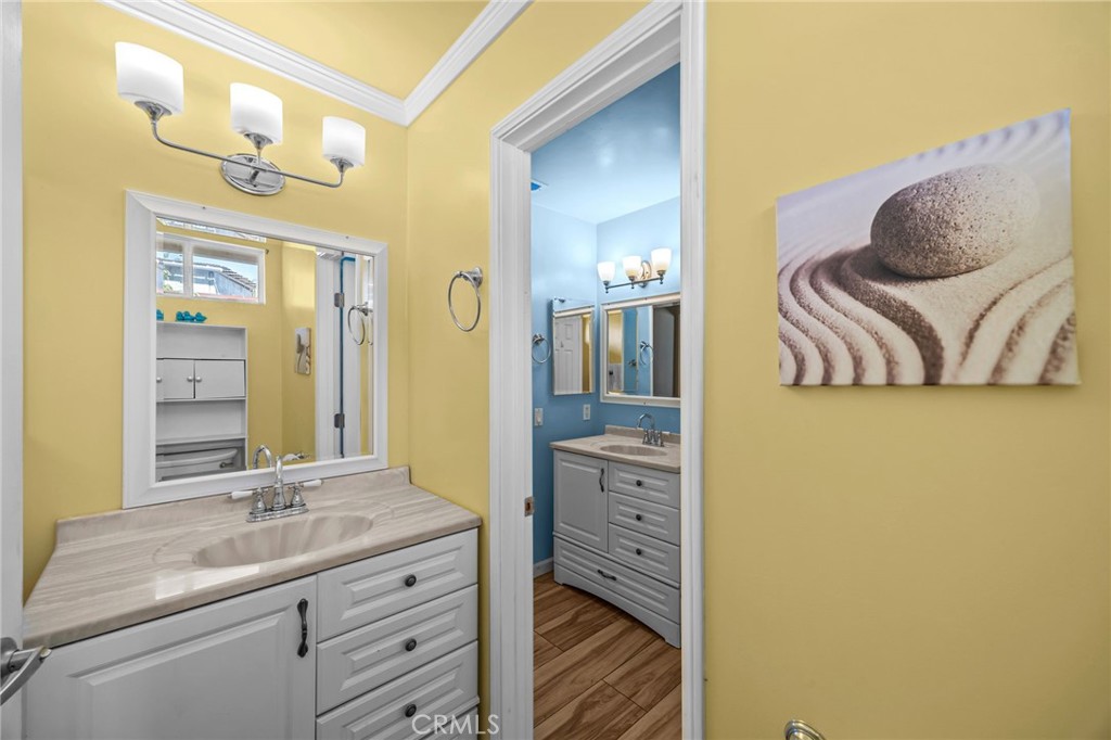 820 Cozy Court Fallbrook, CA 92028 - Photo 23 of 38 a bathroom with a granite countertop sink and a mirror