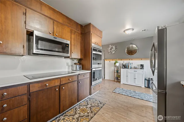 a kitchen with stainless steel appliances cabinets a sink and a oven