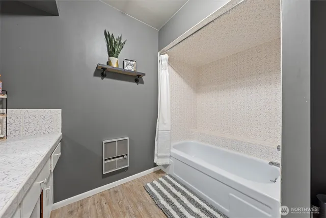 a bathroom with a granite countertop sink a toilet and bathtub