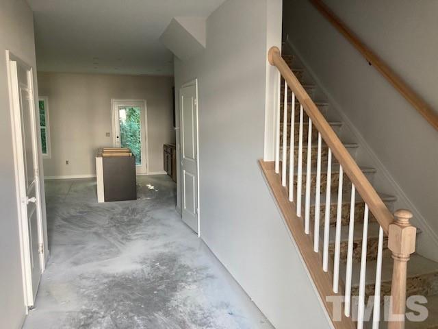 812 Star Rdg Drive Raleigh, NC 27610 - Photo 16 of 23 a view of a hallway with wooden floor and stairs