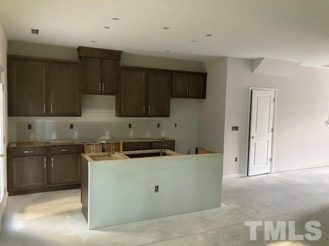 812 Star Rdg Drive Raleigh, NC 27610 - Photo 22 of 23 a kitchen with stainless steel appliances a stove a sink and a refrigerator