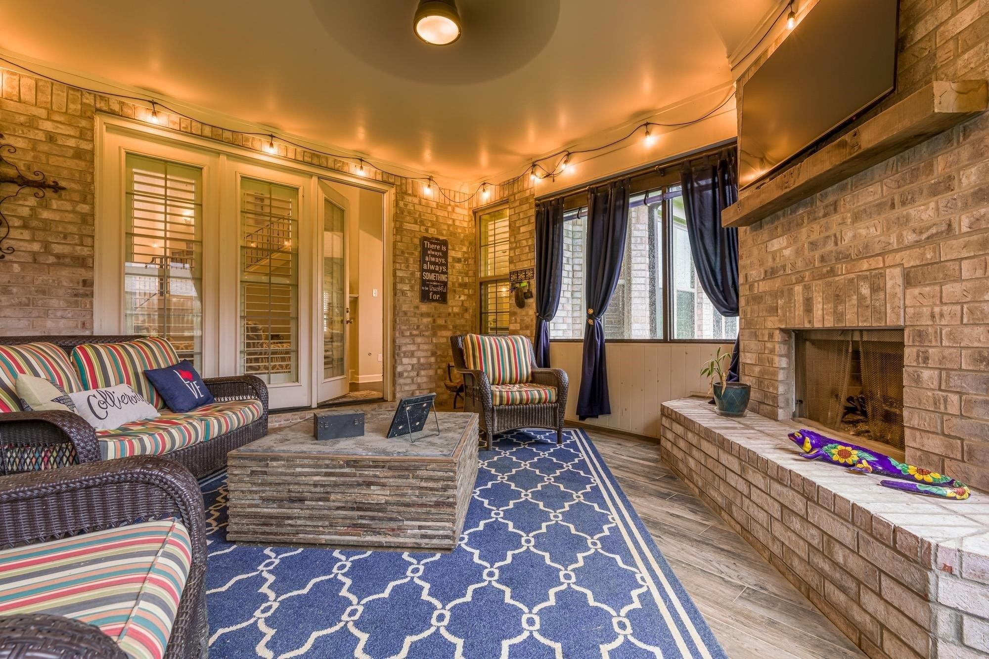 1217 Pilgrim Ridge Road Collierville, TN 38017 - Photo 31 of 33 Living room with brick wall, wood finished floors, and an outdoor brick fireplace