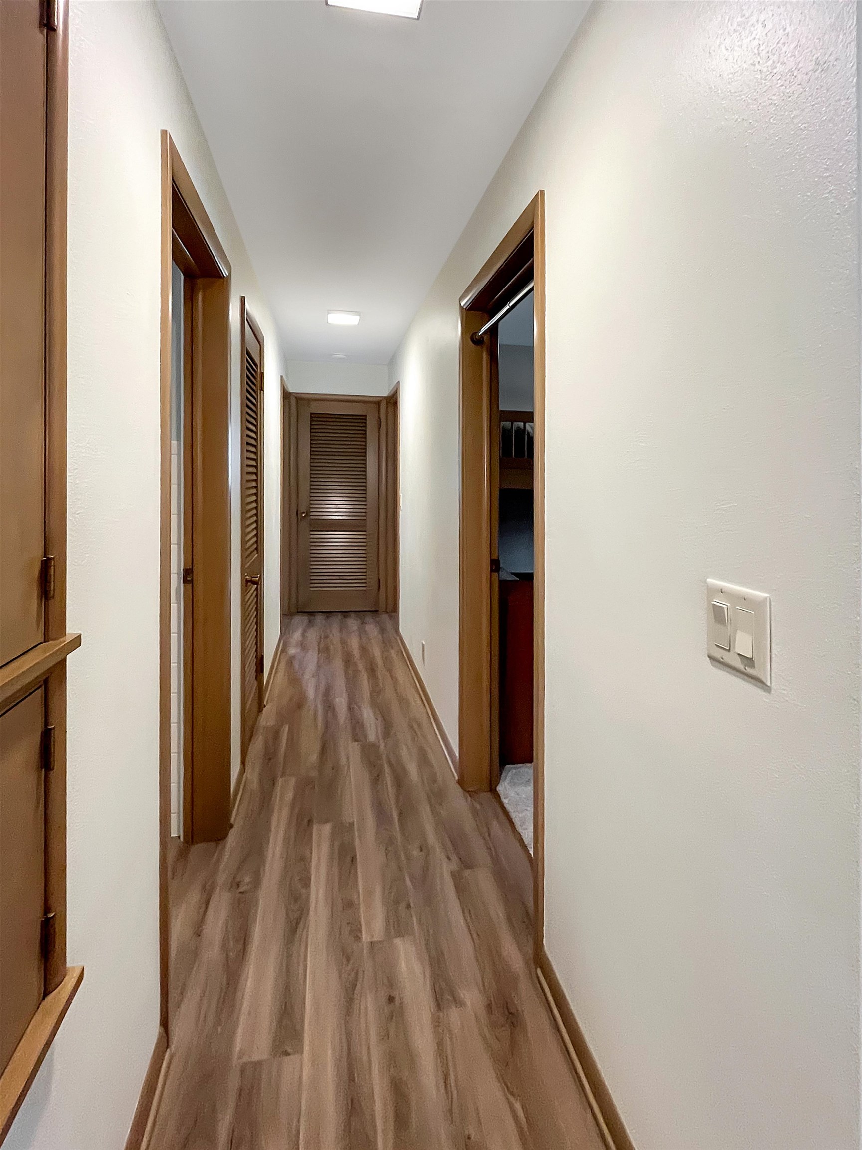 11 East Division Road Shannon, IL 61078 - Photo 11 of 33 a view of a hallway with wooden floor and a bathroom