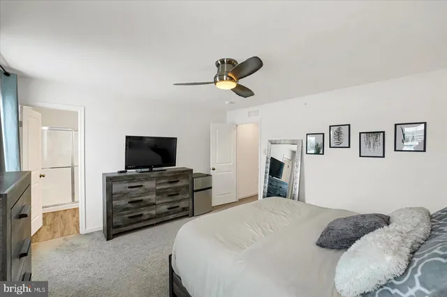 a bedroom with a bed and flat screen tv