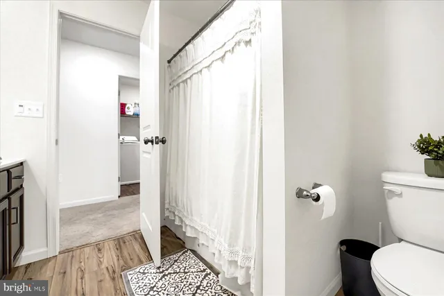 a bathroom with a toilet and a shower