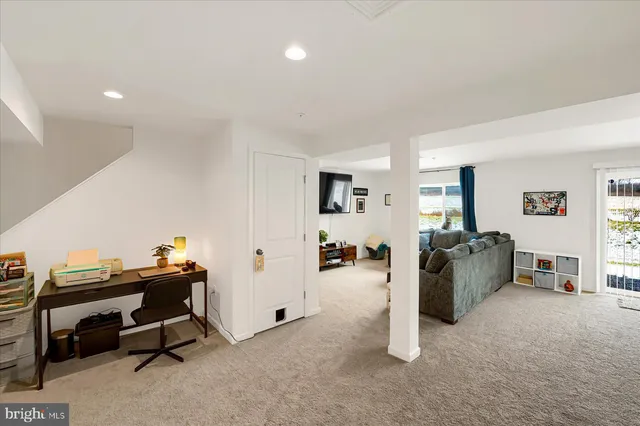 a view of a livingroom with workspace and a window