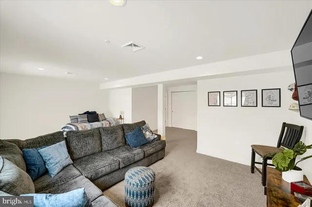 a living room with furniture a couch and a window