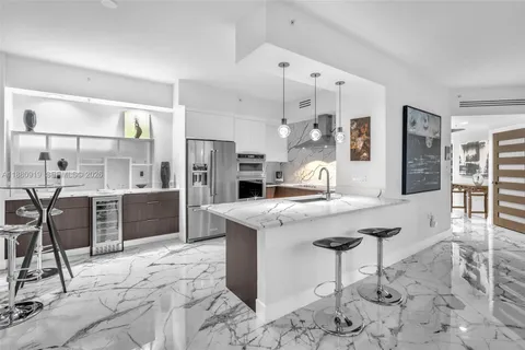a kitchen with stainless steel appliances kitchen island granite countertop a sink and cabinets