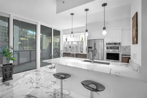 a kitchen with granite countertop a sink and a counter top space