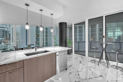 a spacious bathroom with a granite countertop sink a mirror and a shower