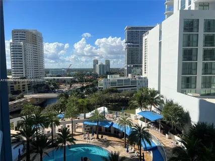 a view of a living room with furniture and floor to ceiling window