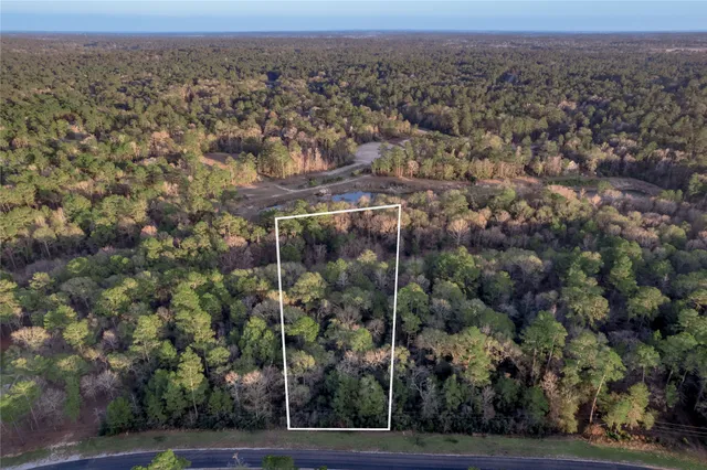 an aerial view of a house with a street