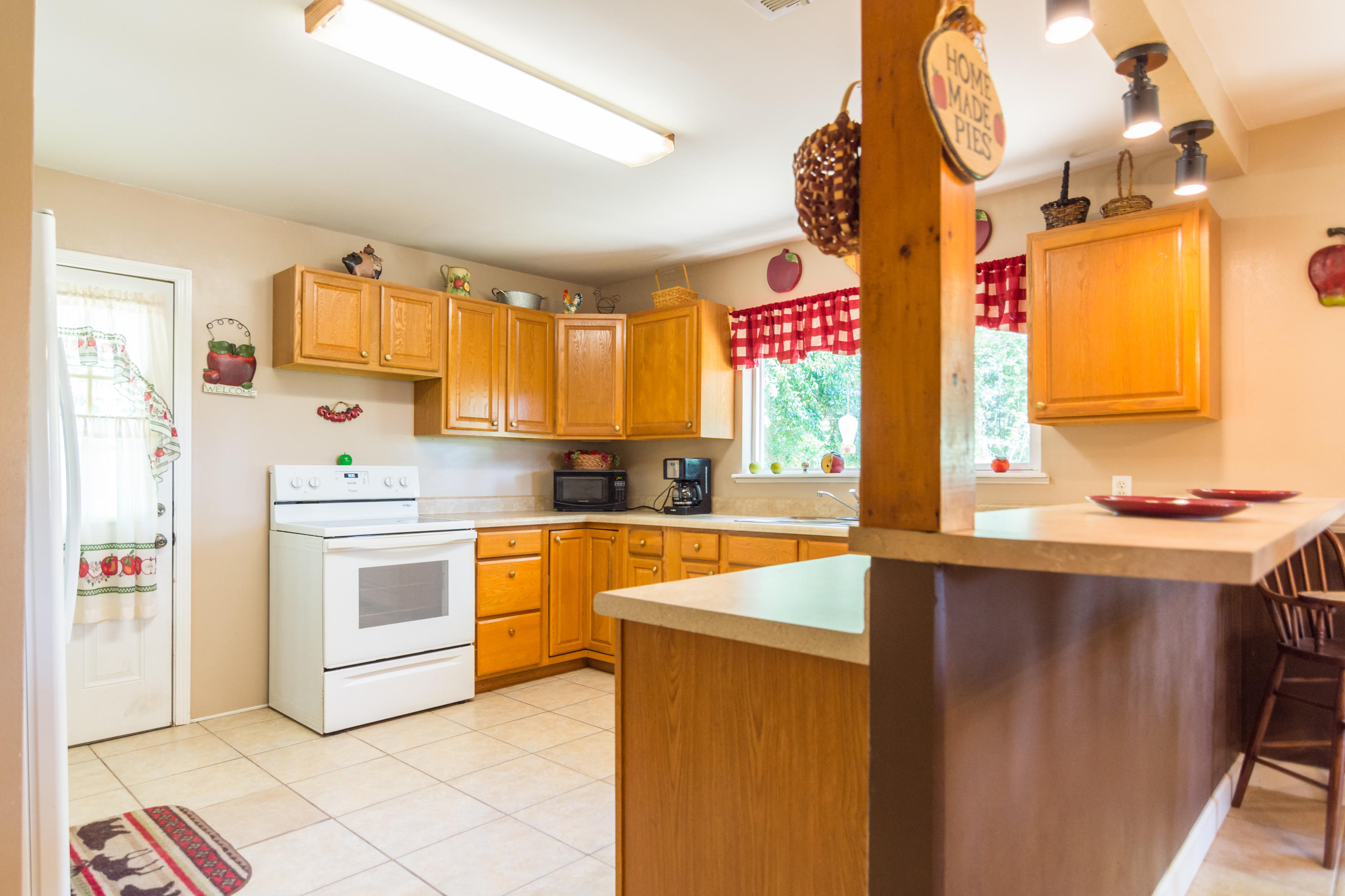 8322 Stokes Road Laurel Hill, FL 32567 - Photo 8 of 25 a kitchen with stainless steel appliances granite countertop a sink and cabinets