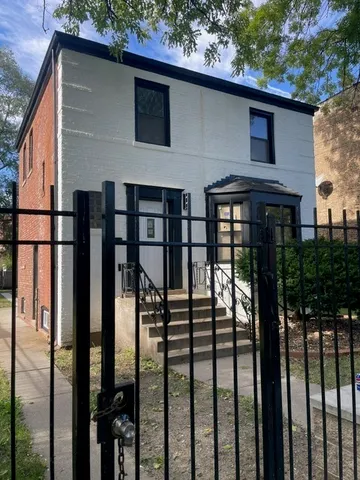 a front view of a house with yard and glass windows