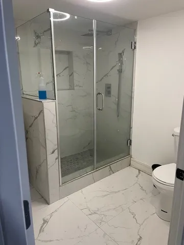 a bathroom with a shower and toilet