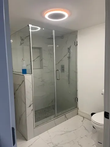 a bathroom with a shower and toilet