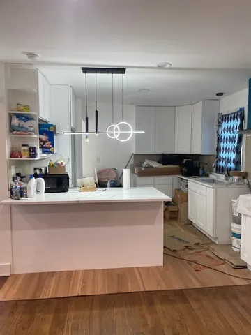 a large kitchen with lots of counter top space and cabinets