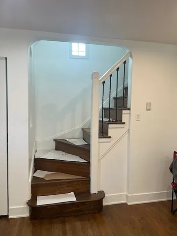 a view of entryway with wooden floor and stairs