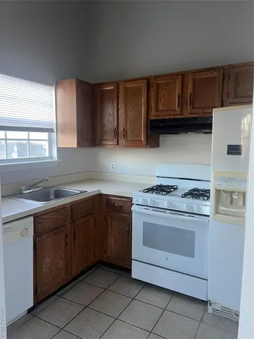 a kitchen with granite countertop cabinets stainless steel appliances and a sink