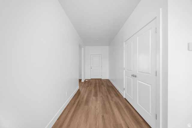 1510 West 600 North, Unit 4A Mapleton, UT 84664 - Photo 8 of 23 Hallway with wood finished floors and a textured ceiling