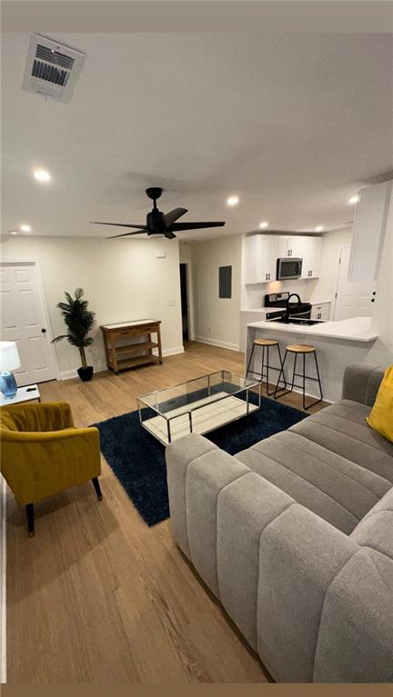 a living room with furniture pool table and chairs