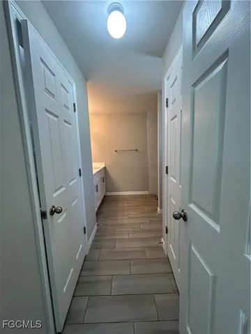 a bathroom with a granite countertop sink toilet and shower curtains