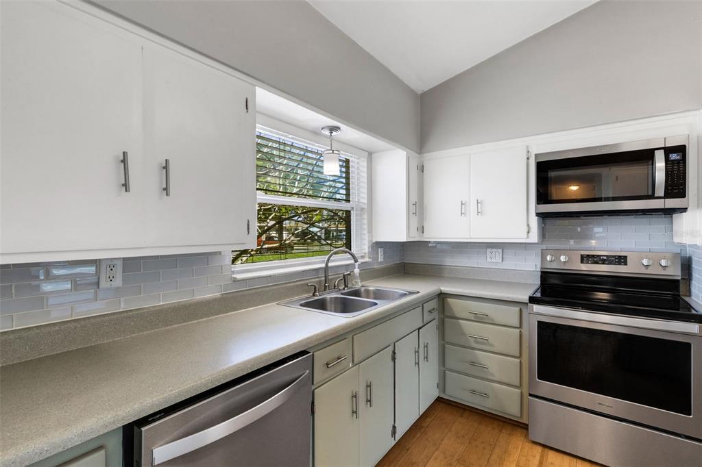 11436 Ridgewood Circle Seminole, FL 33772 - Photo 16 of 38 a kitchen with a sink stove and microwave