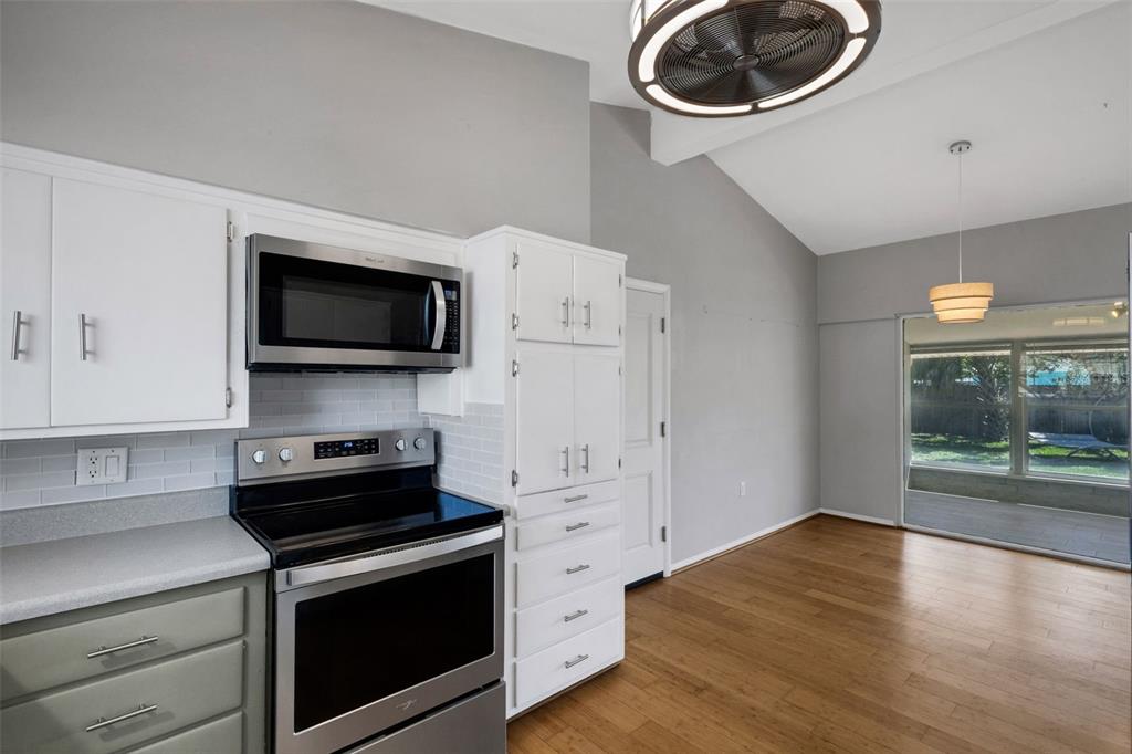 11436 Ridgewood Circle Seminole, FL 33772 - Photo 17 of 38 a kitchen with stainless steel appliances a stove a microwave and a hard wood floors