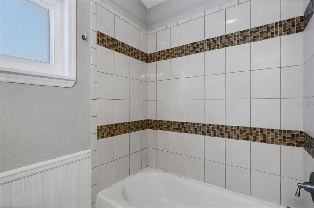 11436 Ridgewood Circle Seminole, FL 33772 - Photo 24 of 38 a bathroom with a bathtub and shower