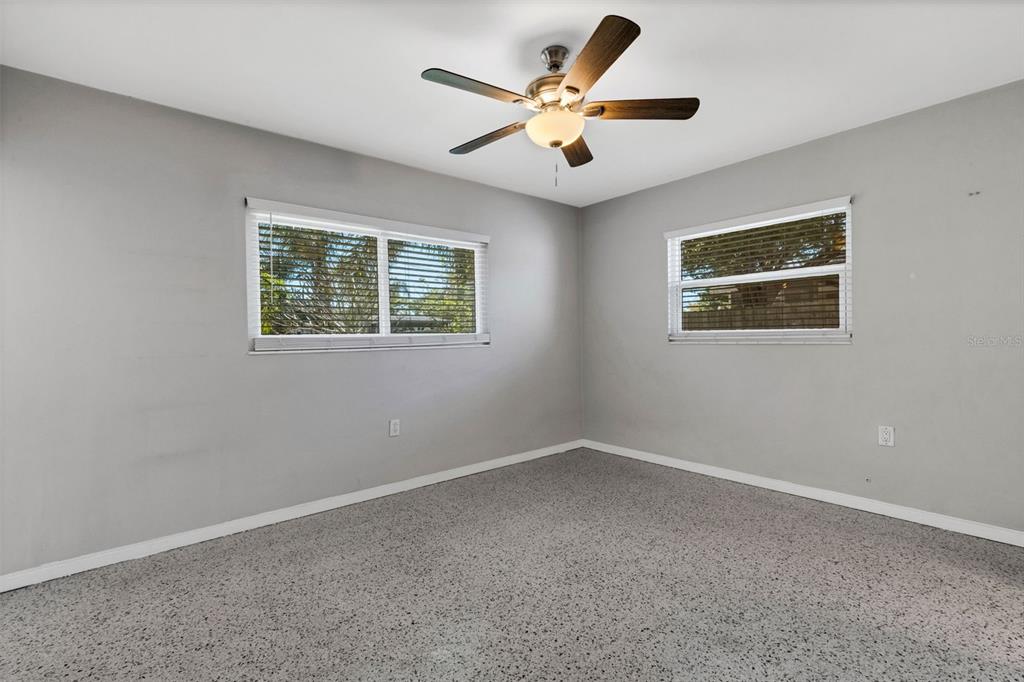 11436 Ridgewood Circle Seminole, FL 33772 - Photo 25 of 38 an empty room with a window and a fan