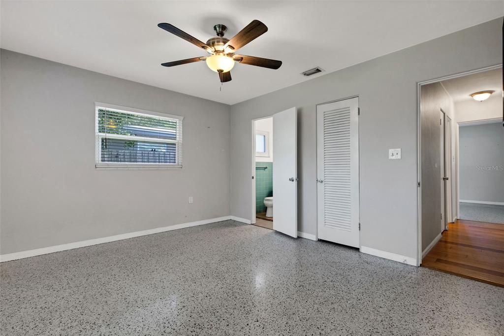 11436 Ridgewood Circle Seminole, FL 33772 - Photo 26 of 38 an empty room with windows and fan