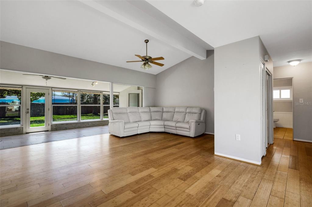 11436 Ridgewood Circle Seminole, FL 33772 - Photo 7 of 38 a view of an empty room with wooden floor and a window