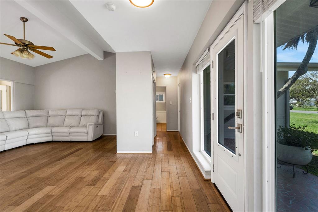 11436 Ridgewood Circle Seminole, FL 33772 - Photo 8 of 38 a view of a bedroom with wooden floor and windows