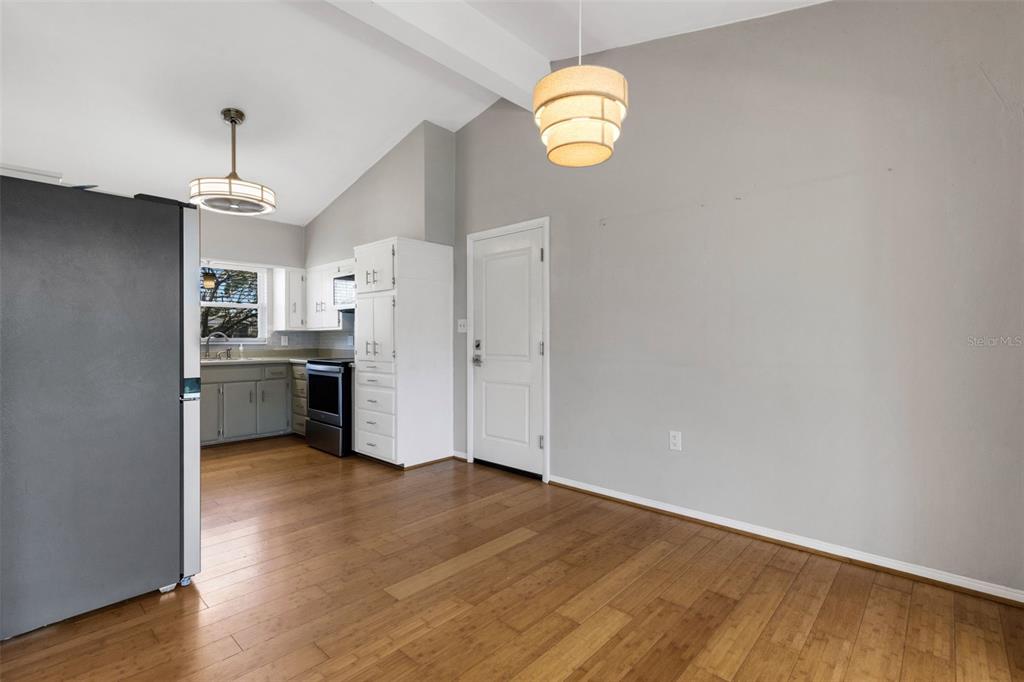 11436 Ridgewood Circle Seminole, FL 33772 - Photo 10 of 38 a view of a kitchen with wooden floor and stainless steel appliances