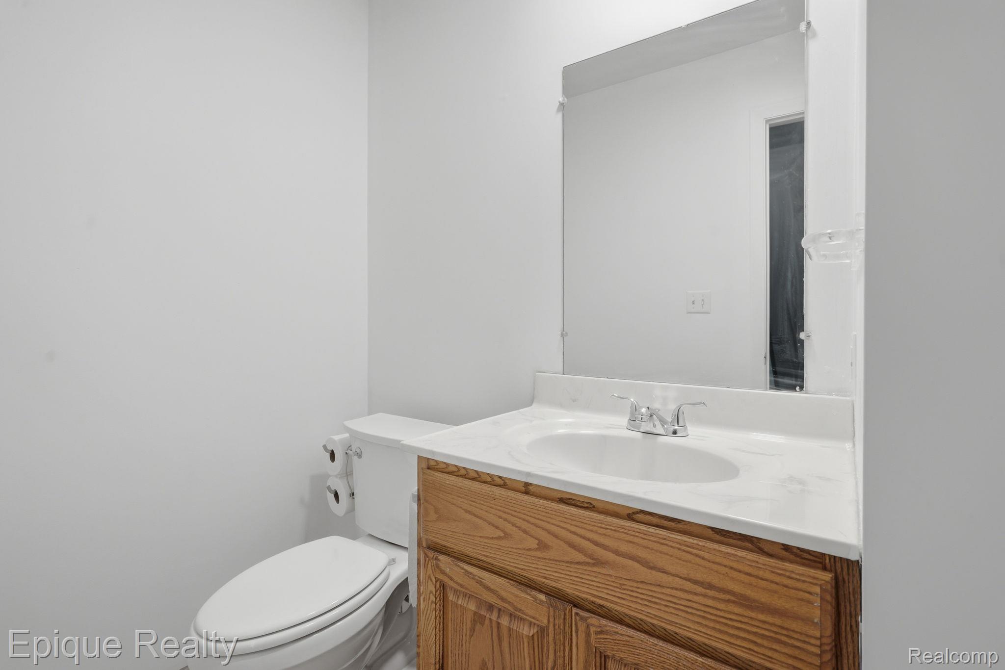 3895 Old Creek Road Troy, MI 48084 - Photo 15 of 23 Half bath featuring vanity and toilet