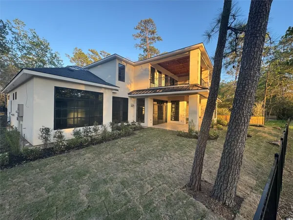 a view of a house with a tree in front of it