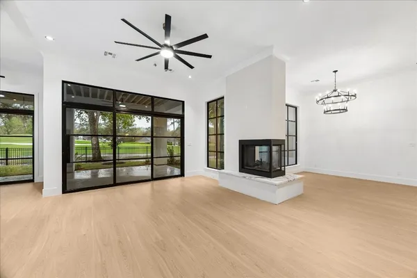 a view of an empty room with a fireplace and a window
