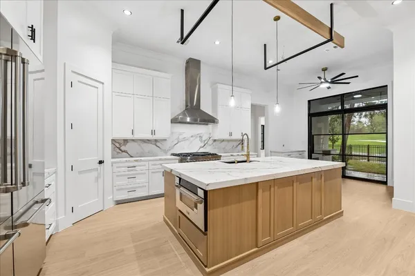 a kitchen that has a lot of cabinets in it
