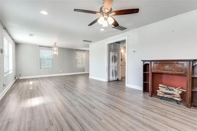 a view of room with wooden floor and ceiling fan