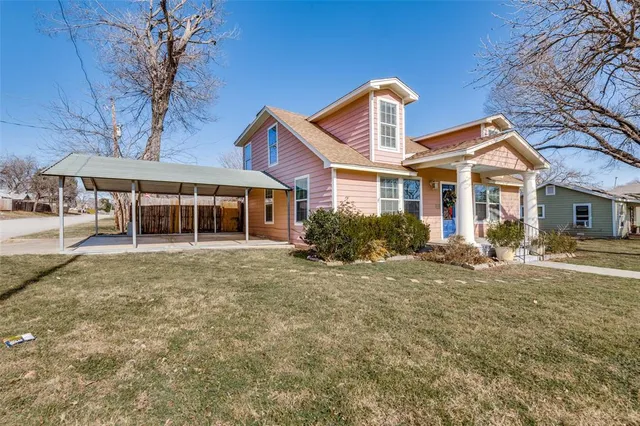a front view of a house with a yard