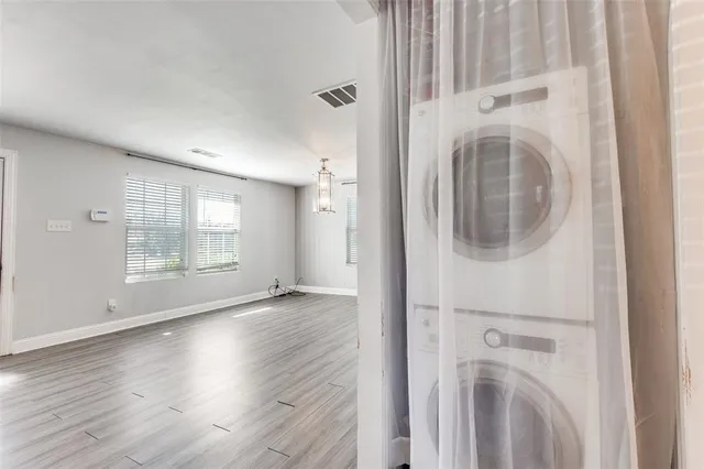 a view of a hallway with wooden floor and entryway