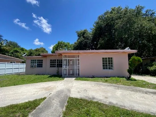 a front view of house with yard and trees