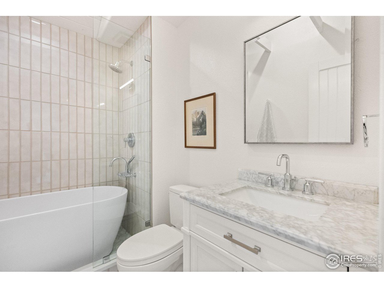 3244 Vallejo Street Denver, CO 80211 - Photo 12 of 32 a bathroom with a granite countertop toilet a sink a mirror a bathtub and shower