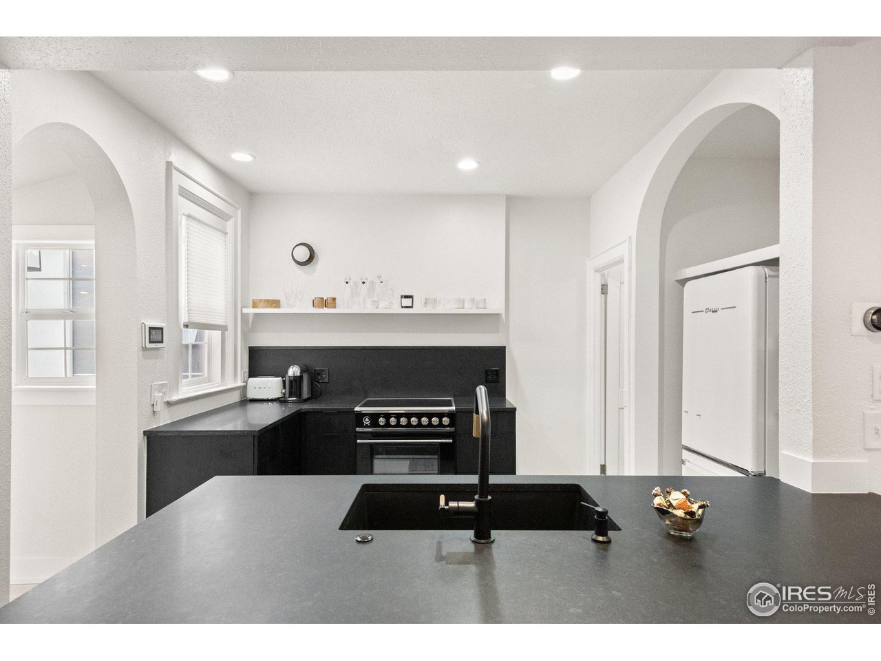 3244 Vallejo Street Denver, CO 80211 - Photo 23 of 32 a kitchen with a refrigerator and a stove