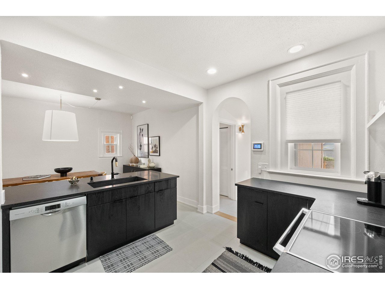 3244 Vallejo Street Denver, CO 80211 - Photo 5 of 32 a kitchen with granite countertop a sink and cabinets