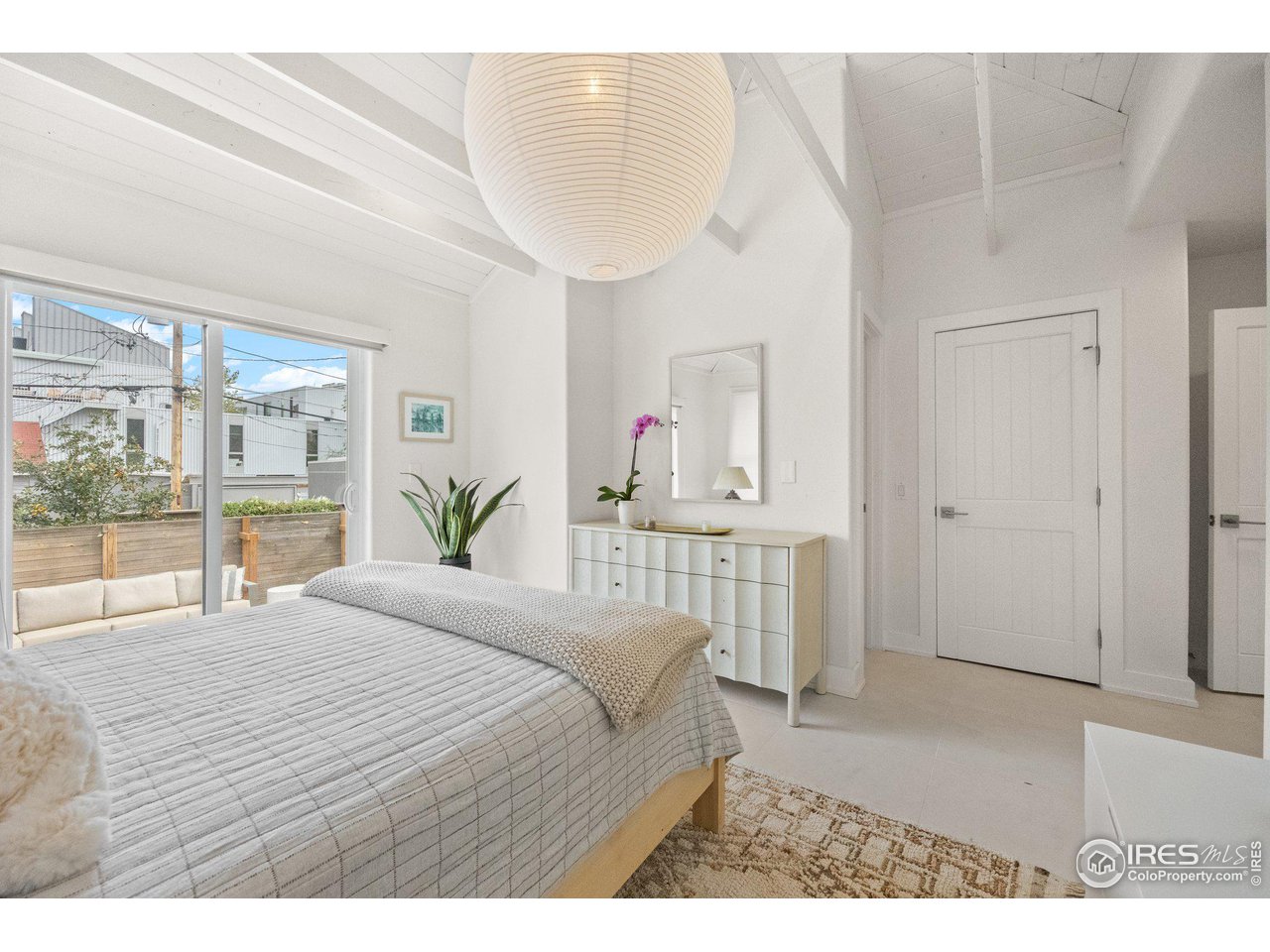 3244 Vallejo Street Denver, CO 80211 - Photo 9 of 32 a bedroom with a large bed and a large window